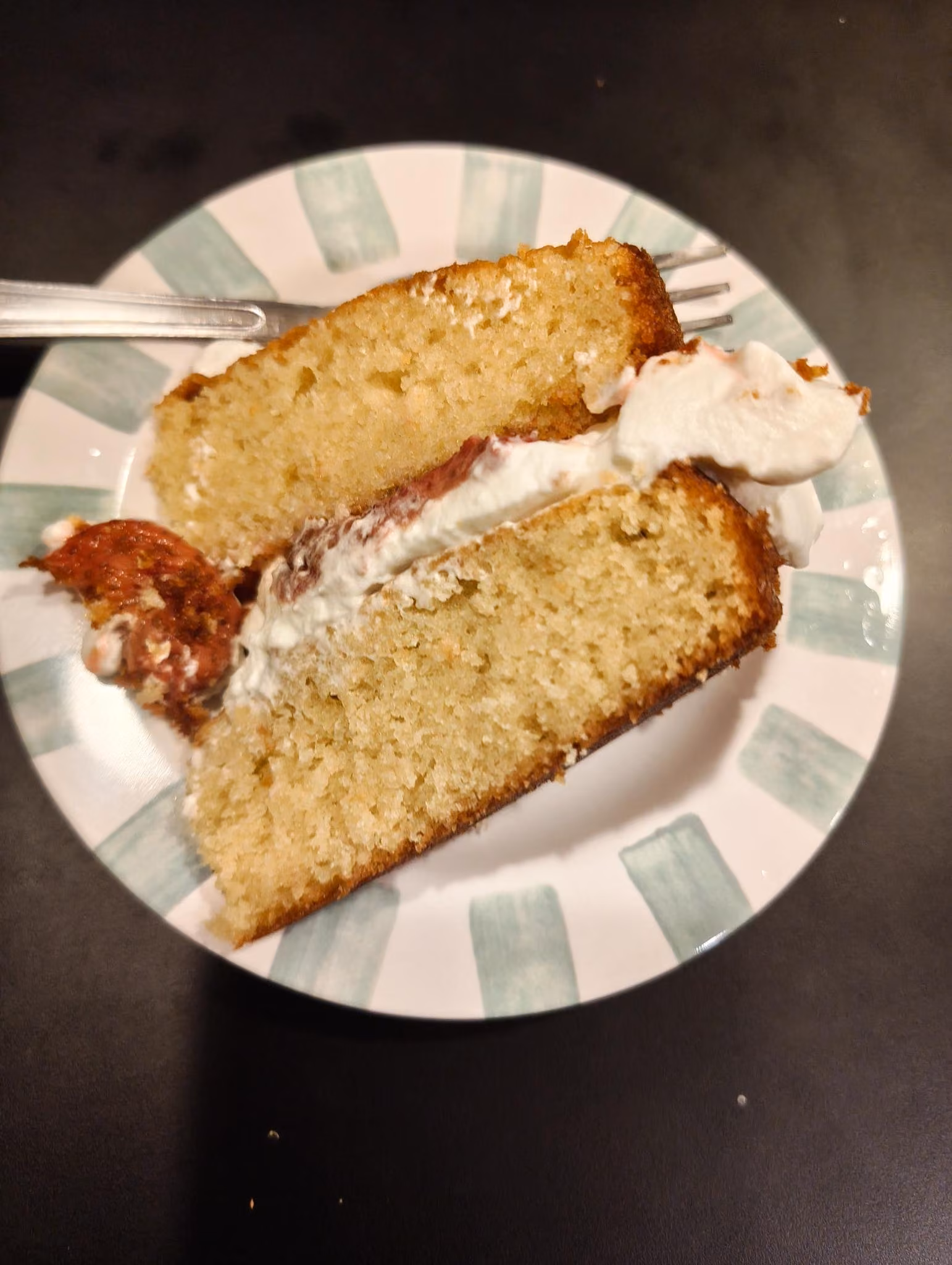 Bird's eye view of two-tiered cake slice lying on a plate